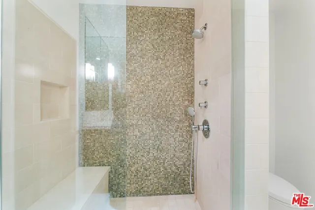 a room with a bed and a wooden floor