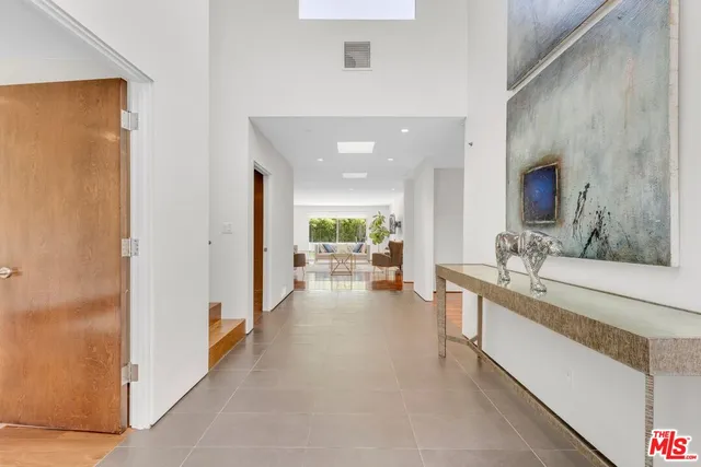a living room with furniture a flat screen tv and wooden floor