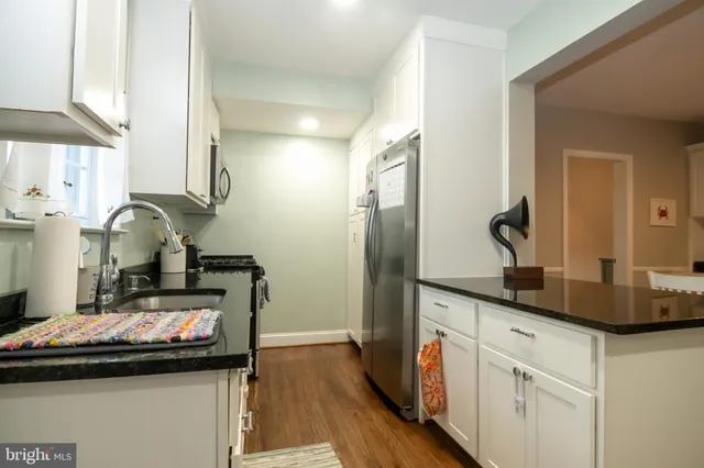 a kitchen with kitchen island a sink appliances and cabinets