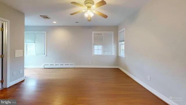 a view of a livingroom with furniture wooden floor and window
