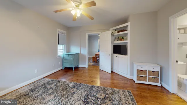 a bedroom with a large bed and a tv