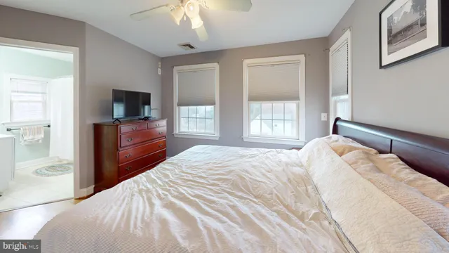 a bedroom with a large bed and a tv