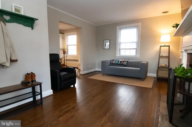 a living room with furniture window and wooden floor