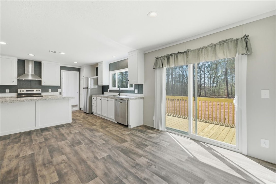 205 Union Court West Union, SC 29696 - Photo 12 of 28 The kitchen offers modern appliances, ample counter space, and direct access to outdoor living.