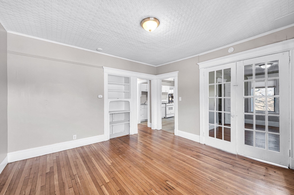 92 Woodside Terrace, Unit 2R Springfield, MA 01108 - Photo 11 of 42 wooden floor in an empty room with a window