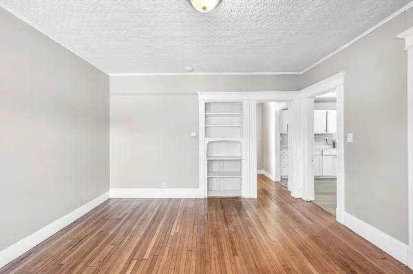 a view of room with wooden floor