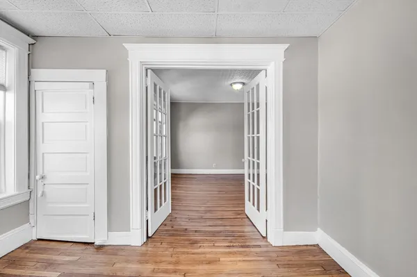 a view of a hallway with wooden floor