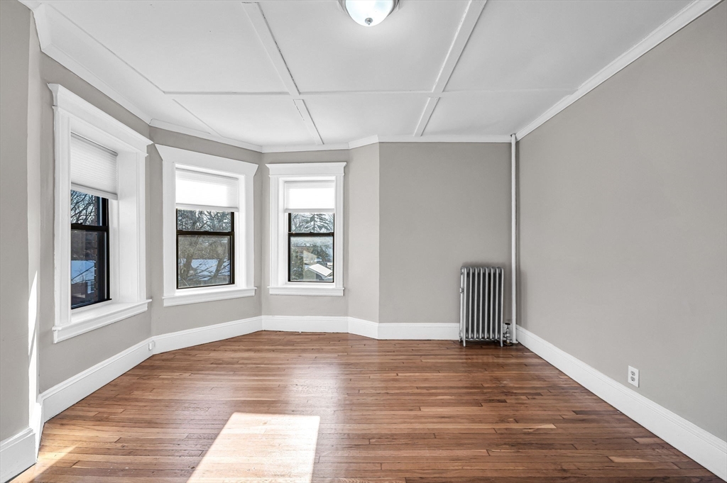 92 Woodside Terrace, Unit 2R Springfield, MA 01108 - Photo 20 of 42 a view of empty room with wooden floor and fan