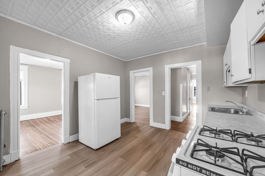 92 Woodside Terrace, Unit 2R Springfield, MA 01108 - Photo 2 of 42 a kitchen with a stove and a refrigerator