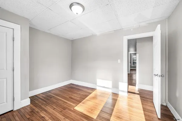 a view of an empty room and wooden floor