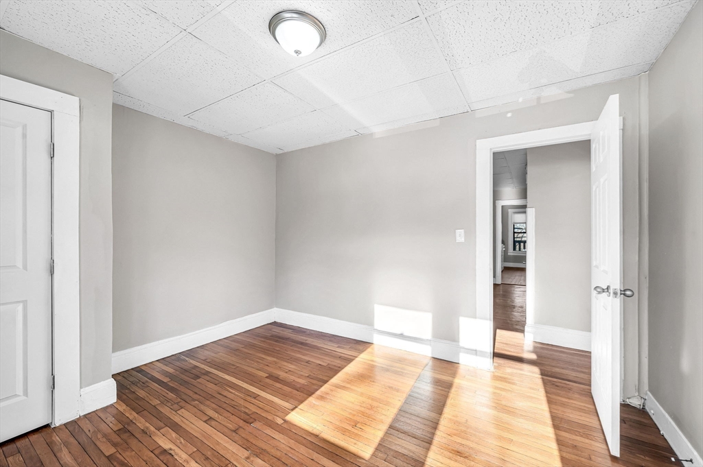 92 Woodside Terrace, Unit 2R Springfield, MA 01108 - Photo 25 of 42 a view of an empty room and wooden floor