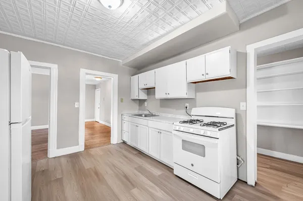 a kitchen with stainless steel appliances granite countertop a stove and a refrigerator