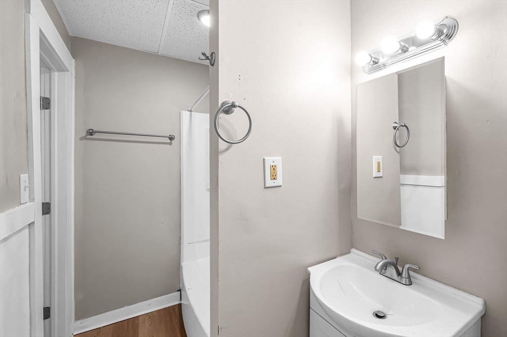 92 Woodside Terrace, Unit 2R Springfield, MA 01108 - Photo 31 of 42 a bathroom with a sink a mirror and shower