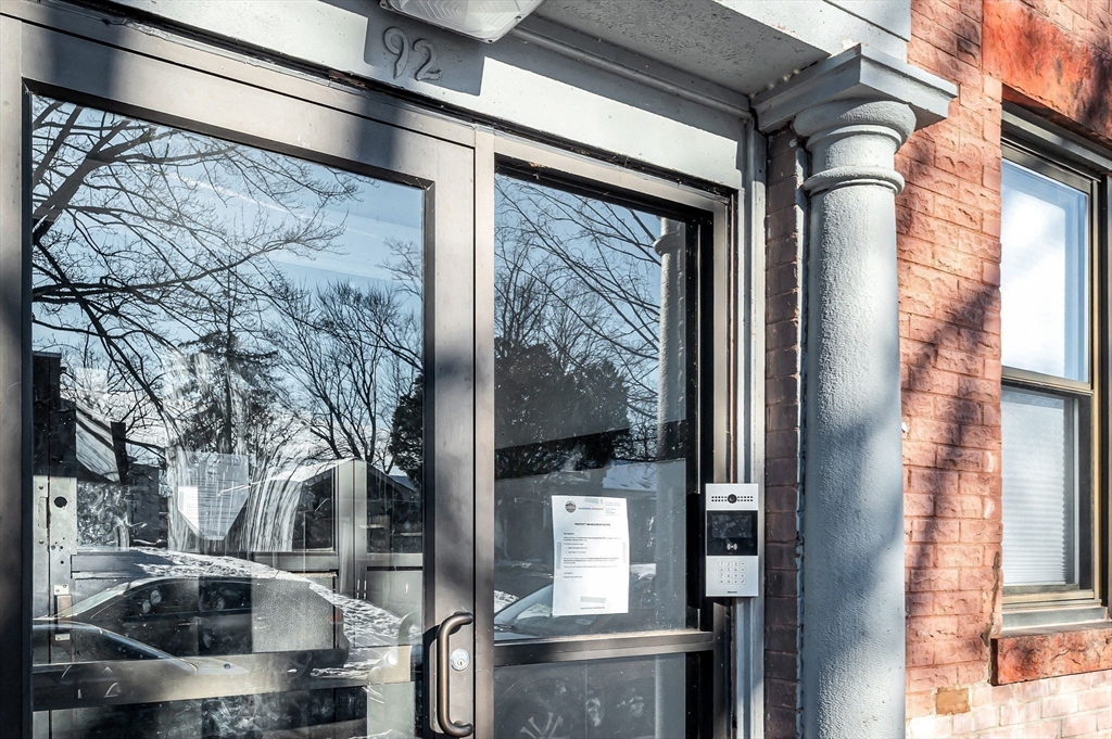 92 Woodside Terrace, Unit 2R Springfield, MA 01108 - Photo 35 of 42 a front view of a building with a glass door