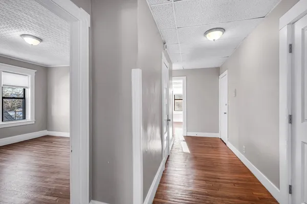 a view of a hallway with wooden floor