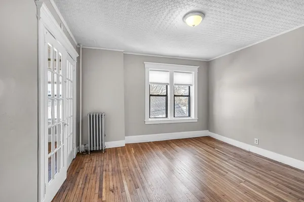 wooden floor in an empty room with a window