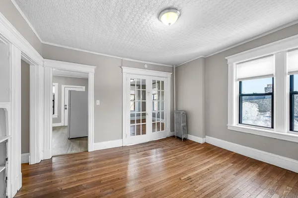 wooden floor in an empty room with a window