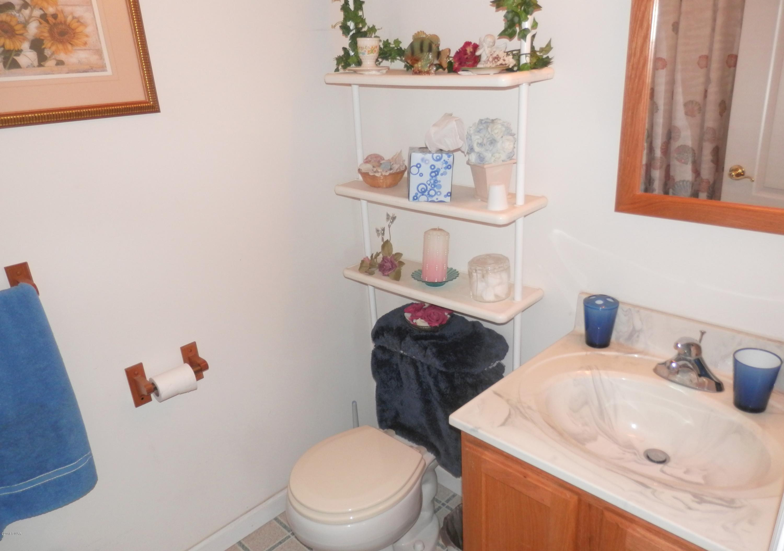 176 Highland Road Pleasant Mount, PA 18453 - Photo 26 of 52 a white toilet sitting next to a bathroom sink