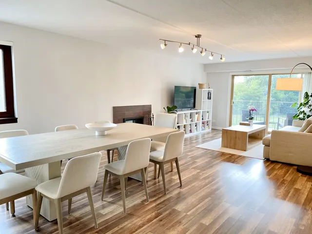 a view of a dining room with furniture wooden floor and chandelier