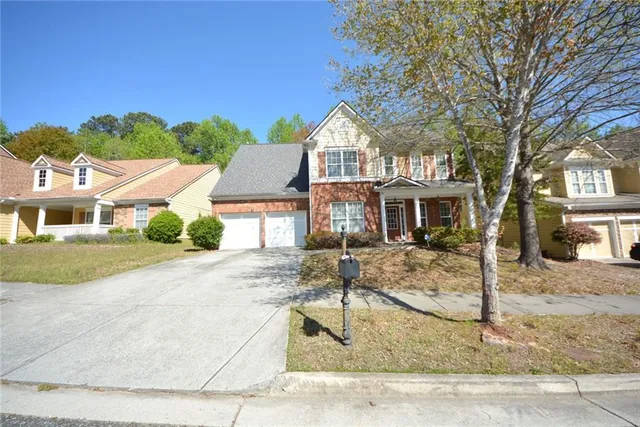 a front view of a house with garden