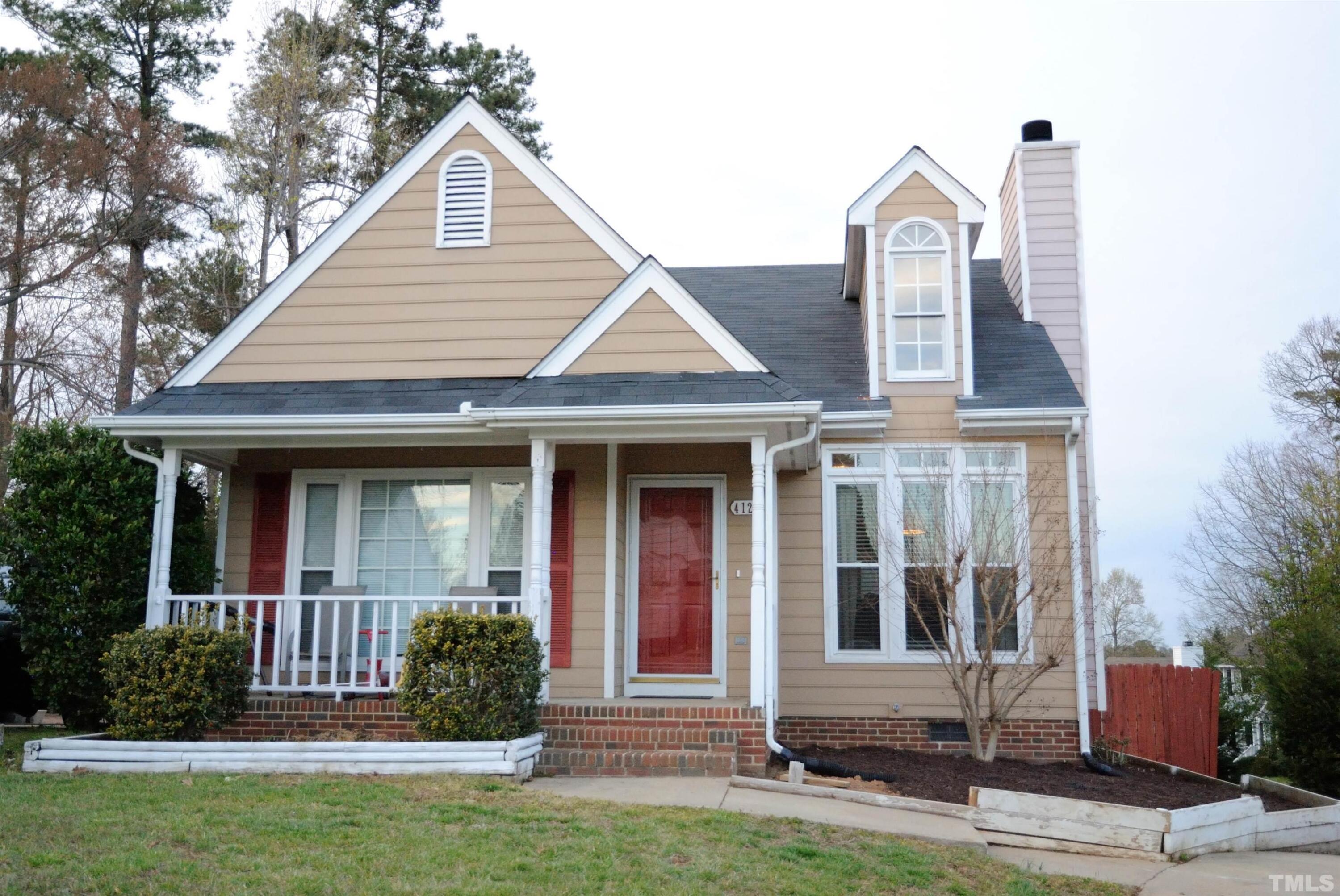 4125 Cobble Court Raleigh, NC 27616 - Photo 1 of 12 a front view of a house with a yard