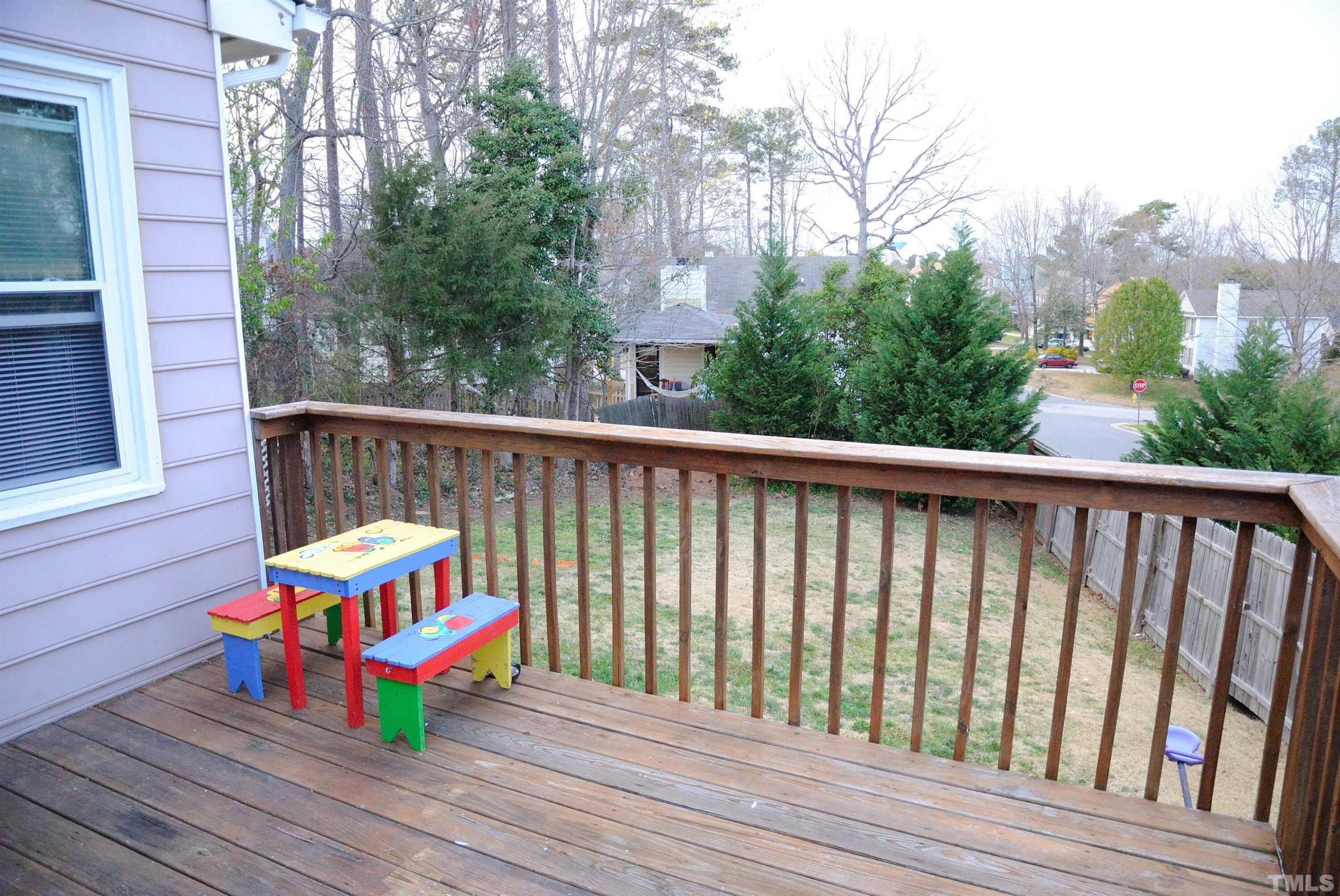 4125 Cobble Court Raleigh, NC 27616 - Photo 11 of 12 a wooden bench sitting in front of a building