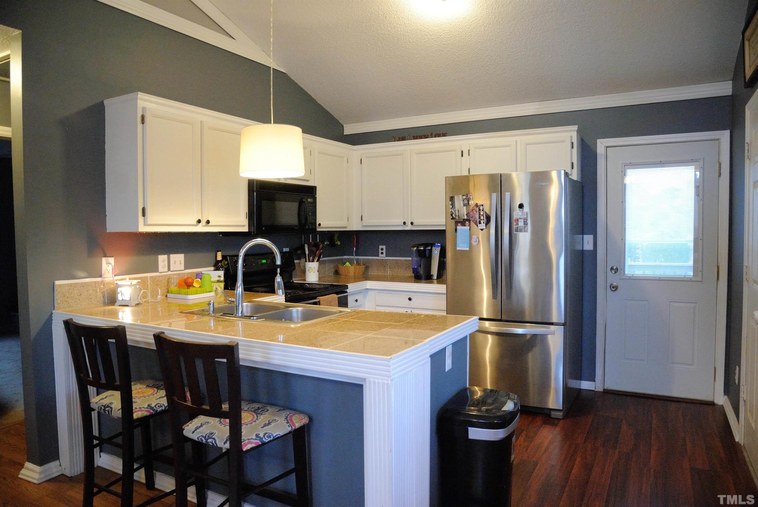 4125 Cobble Court Raleigh, NC 27616 - Photo 2 of 12 a kitchen with a sink appliances and cabinets