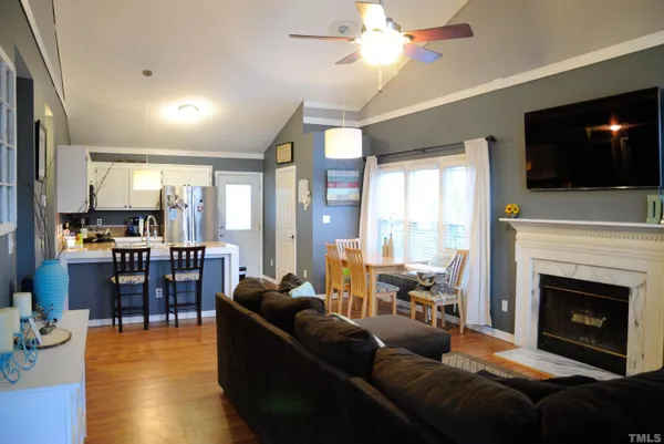 a living room with furniture fireplace and flat screen tv