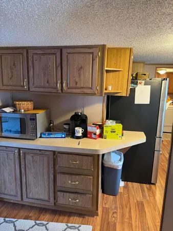 a kitchen with a sink a stove and cabinets