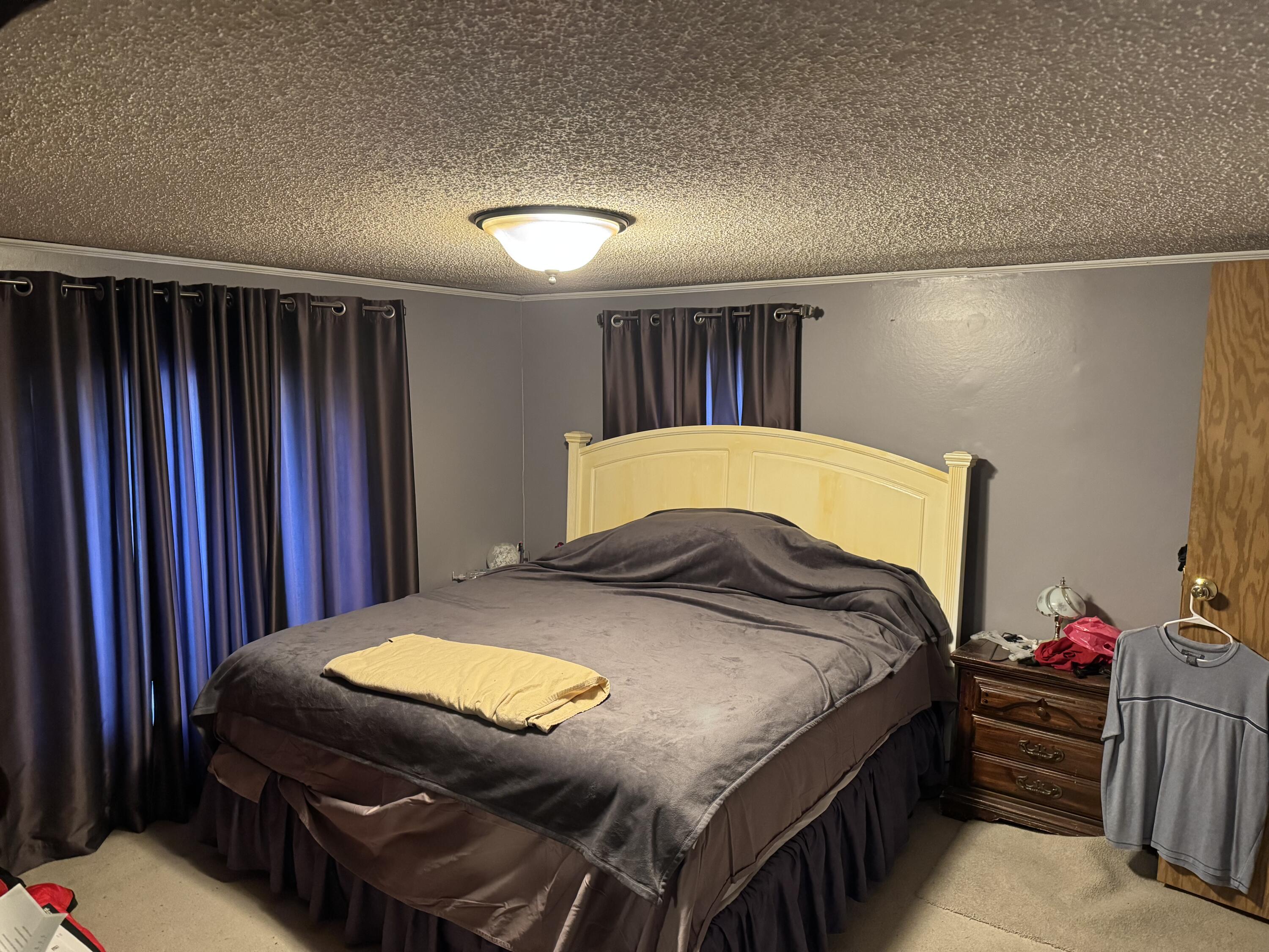 25 East Carter Street Wheatfield, IN 46392 - Photo 12 of 22 a bedroom with bed and a closet