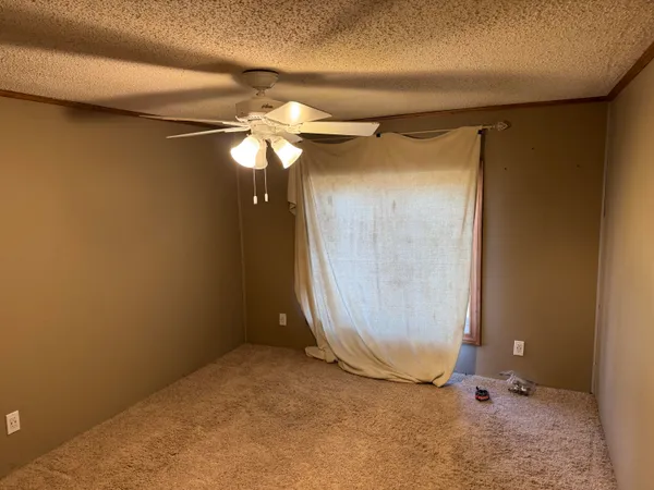 an empty room with a glass door shower