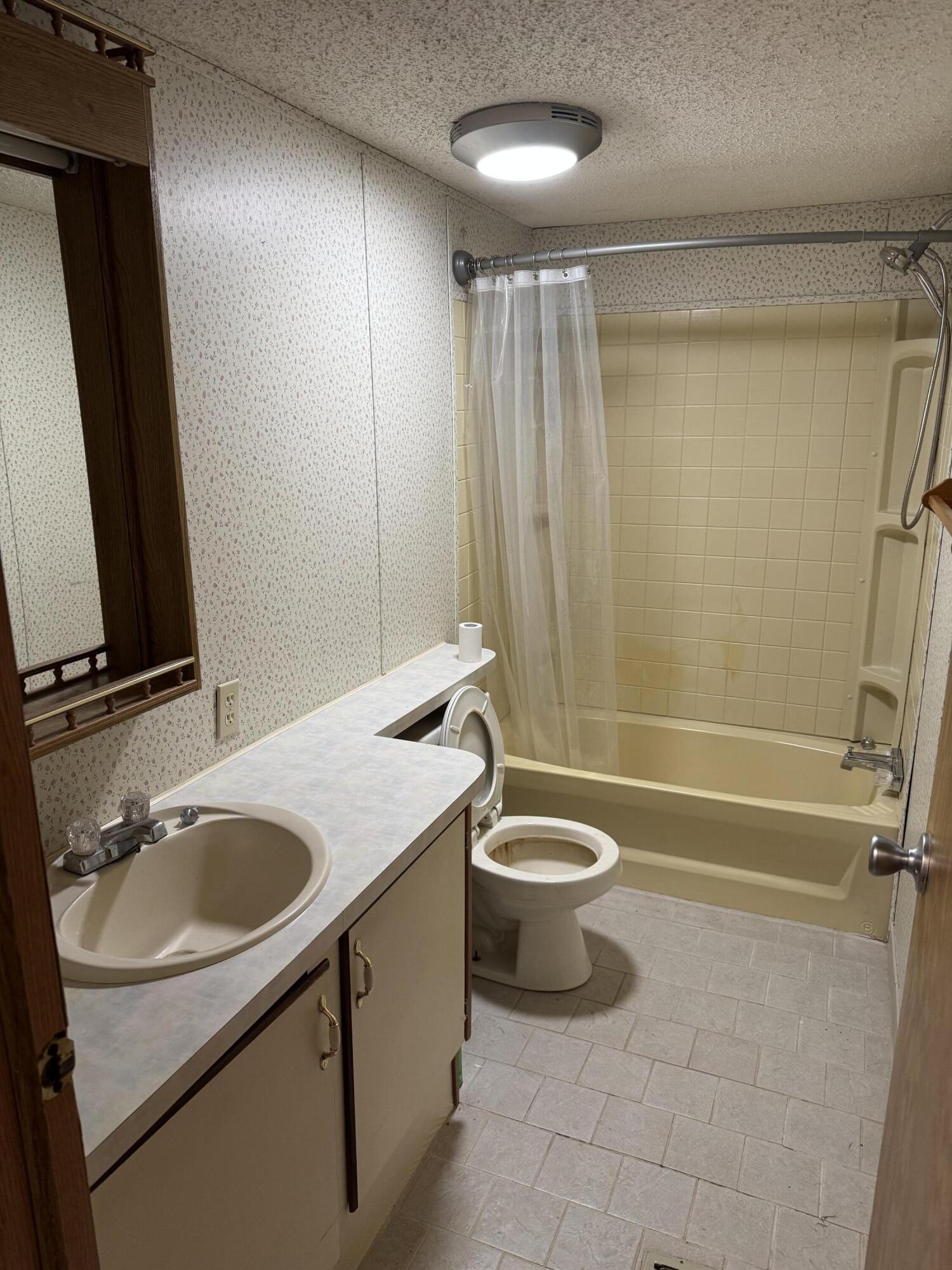 25 East Carter Street Wheatfield, IN 46392 - Photo 16 of 22 a bathroom with a granite countertop sink toilet and shower