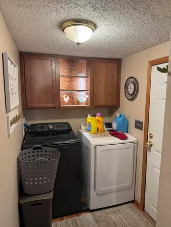 a view of a storage and utility room with washer and dryer