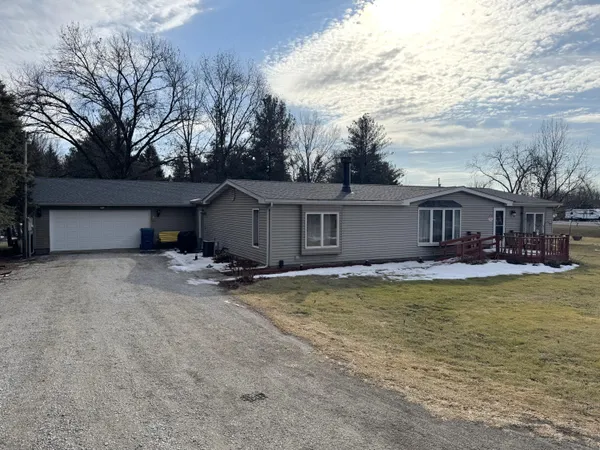 a view of a house with swimming pool and sitting area