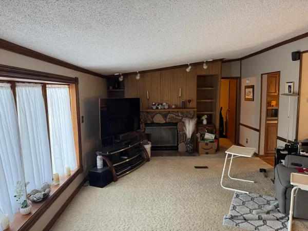 a room with gym equipment and a flat screen tv