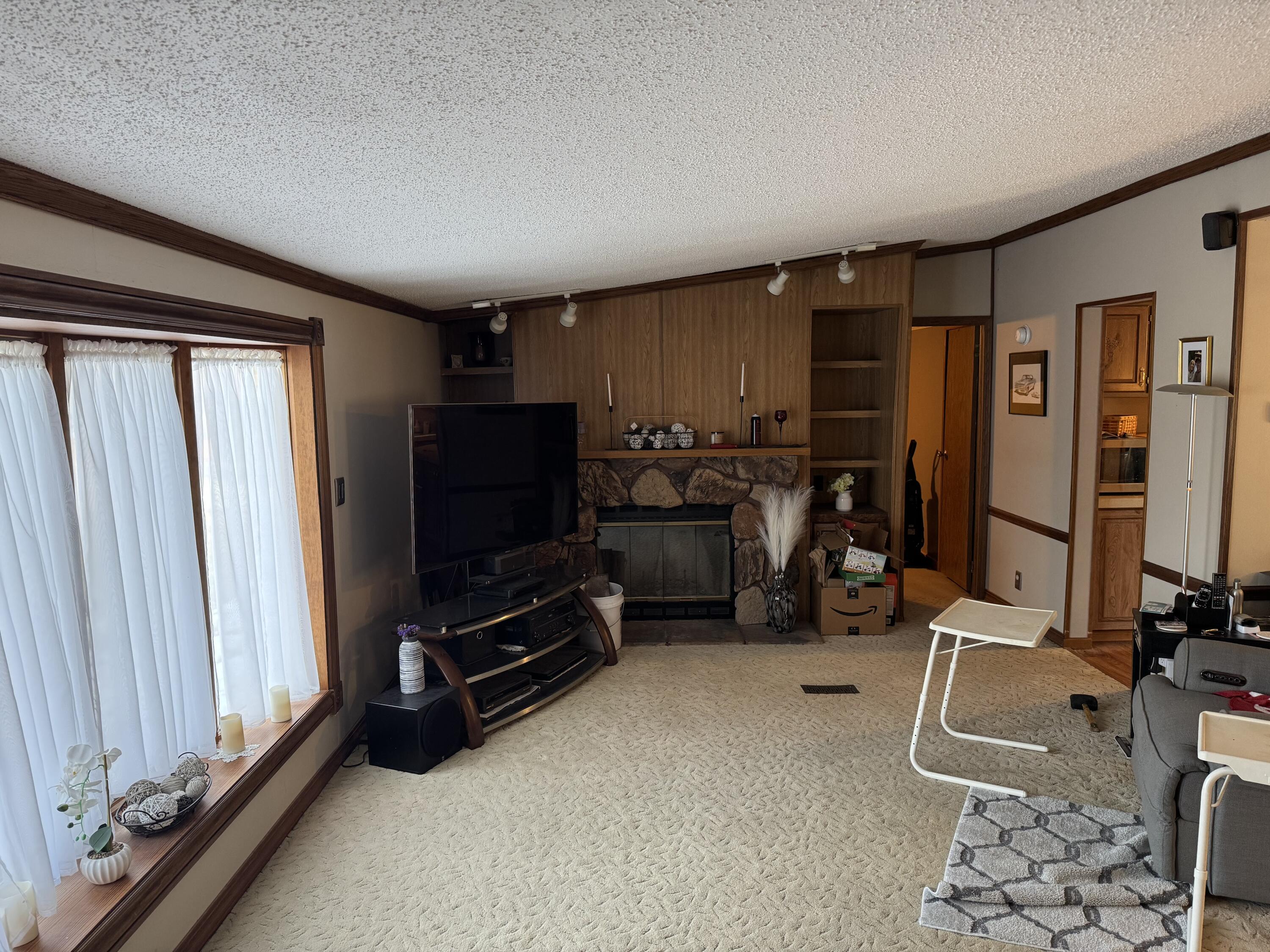 25 East Carter Street Wheatfield, IN 46392 - Photo 6 of 22 a room with gym equipment and a flat screen tv