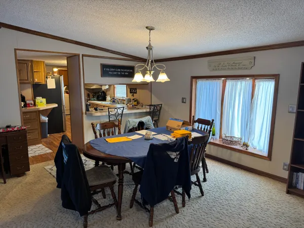 a view of a dining room with furniture and window