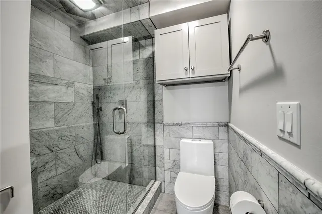 a bathroom with a toilet and shower