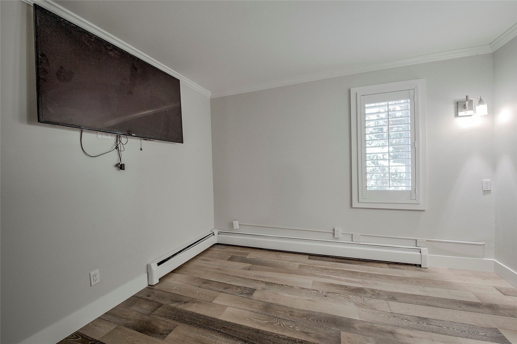 1120 Ski Hill Road, Unit 16 Breckenridge, CO 80424 - Photo 16 of 23 a view of an empty room with wooden floor and a window