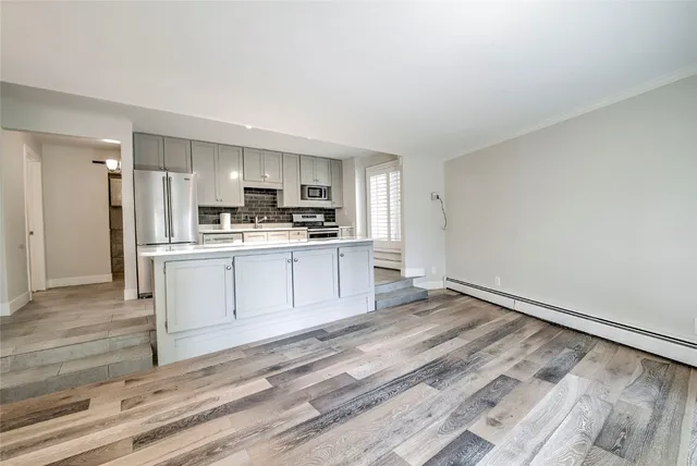 a view of kitchen with wooden floor
