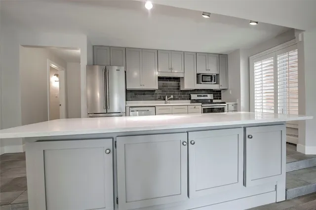 a kitchen with appliances cabinets and a sink