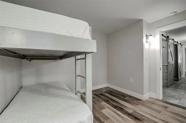 a bedroom with a bed and a ceiling fan