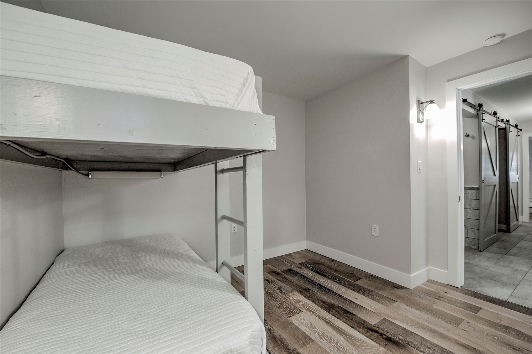 1120 Ski Hill Road, Unit 16 Breckenridge, CO 80424 - Photo 10 of 23 a bedroom with a bed and wooden floor