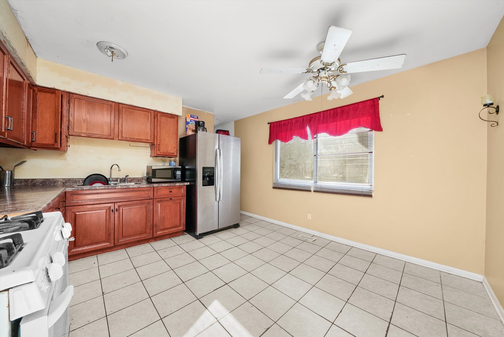 233 Rockhurst Road Bolingbrook, IL 60440 - Photo 18 of 29 a kitchen with granite countertop a stove a microwave oven cabinets and a counter space