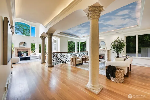 a view of a livingroom with furniture wooden floor and windows