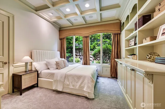 a bedroom with a bed next to a large window with the outer view