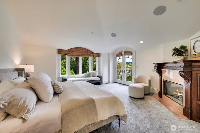 a spacious bedroom with a bed and a large window