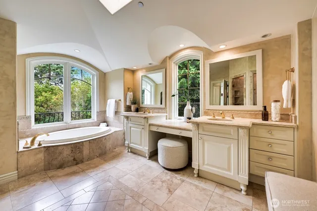 a large spacious bathroom with a large tub and sink