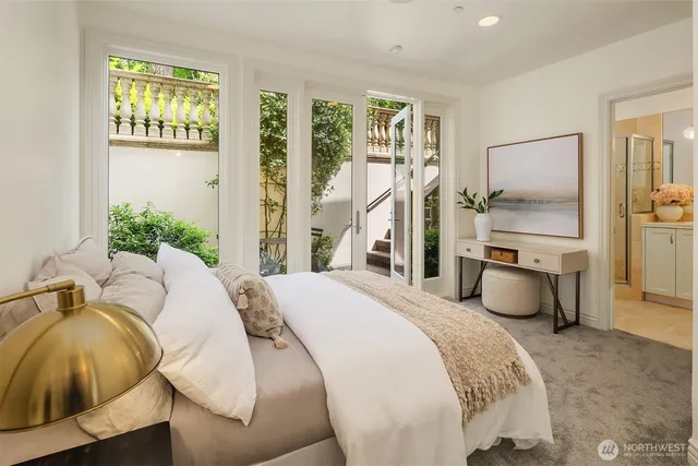 a bedroom with a bed and glass walk in closet