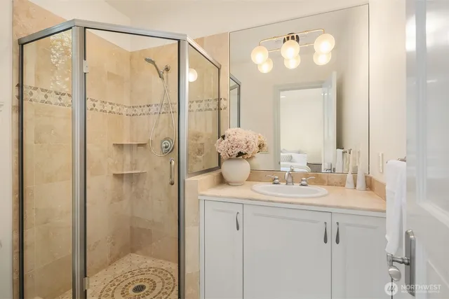 a bathroom with a shower sink and mirror